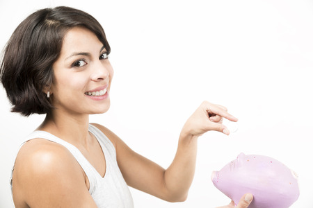 Happy woman holding a piggy bank with saving