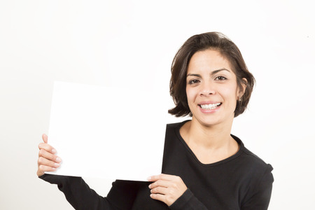 Beautiful young woman holding a blank sheet of paper. Space for your text. Isolated on white.の写真素材