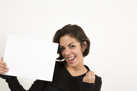 Beautiful young woman holding a blank sheet of paper. Space for your text. Isolated on white.の写真素材