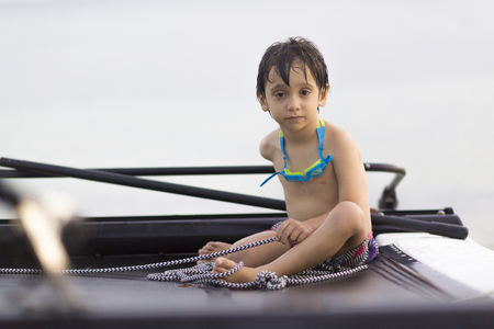 Happy Boy Enjoying Catamaran in beautiful sunsetの写真素材