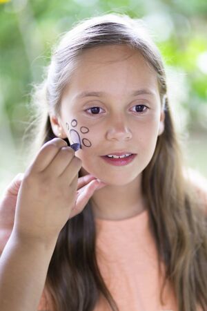 Beautiful Teen Getting her Face Painted, Makeup, Outdoorsの写真素材