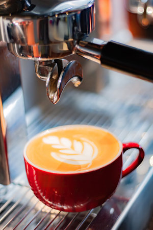 Cup of coffee latte on coffee maker. coffee machine.の写真素材