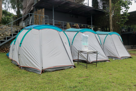 Camping and tent in the riverside. Panoramic landscape. Natural area with trees and green grass. Camping tent. Camping areaの写真素材