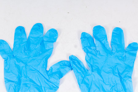Blue gloves for health protection isolated on white background. Medical nitrile gloves. Manufacture of rubber gloves, latex gloves. protective glovesの写真素材