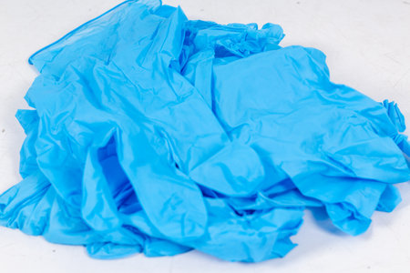 Blue gloves for health protection isolated on white background. Medical nitrile gloves. Manufacture of rubber gloves, latex gloves. protective glovesの写真素材