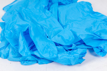 Blue gloves for health protection isolated on white background. Medical nitrile gloves. Manufacture of rubber gloves, latex gloves. protective glovesの写真素材