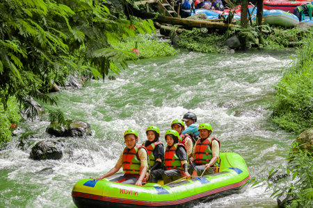 Pangalengan, Bandung-Indonesia December 2022 : A group of men and women are rafting on the river, extreme and fun sport. Group of people water sport raftingのeditorial素材