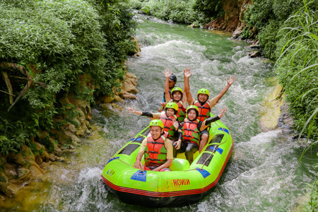 Pangalengan, Bandung-Indonesia December 2022 : A group of men and women are rafting on the river, extreme and fun sport. Group of people water sport raftingのeditorial素材