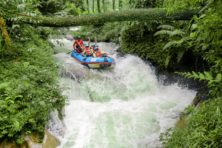 Pangalengan, Bandung-Indonesia December 2022 : A group of men and women are rafting on the river, extreme and fun sport. Group of people water sport raftingのeditorial素材