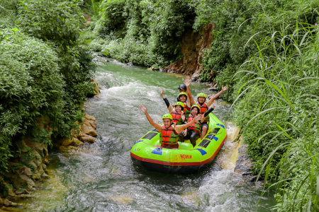 Pangalengan, Bandung-Indonesia December 2022 : A group of men and women are rafting on the river, extreme and fun sport. Group of people water sport raftingのeditorial素材