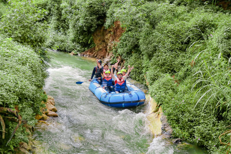 Pangalengan, Bandung-Indonesia December 2022 : A group of men and women are rafting on the river, extreme and fun sport. Group of people water sport raftingのeditorial素材