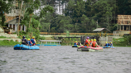 Pangalengan, Bandung-Indonesia December 2022 : A group of men and women are rafting on the river, extreme and fun sport. Group of people water sport raftingのeditorial素材