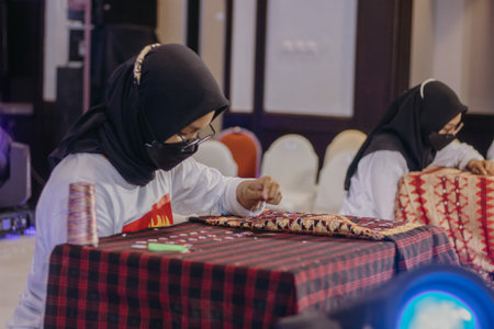 Bandar Lampung, Lampung-Indonesia 21 November 2021: A woman is weaving cloth, or so-called traditional tapis cloth, typical of Lampung province, by handのeditorial素材