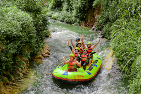 Pangalengan, Bandung-Indonesia December 2022 : A group of men and women are rafting on the river, extreme and fun sport. Group of people water sport raftingのeditorial素材
