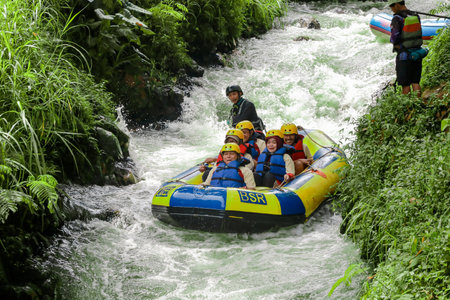 Pangalengan, Bandung-Indonesia December 2022 : A group of men and women are rafting on the river, extreme and fun sport. Group of people water sport raftingのeditorial素材