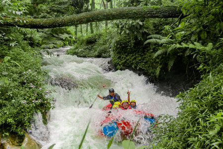 Pangalengan, Bandung-Indonesia December 2022 : A group of men and women are rafting on the river, extreme and fun sport. Group of people water sport raftingのeditorial素材