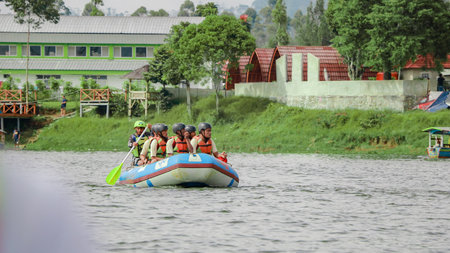 Pangalengan, Bandung-Indonesia December 2022 : A group of men and women are rafting on the river, extreme and fun sport. Group of people water sport raftingのeditorial素材
