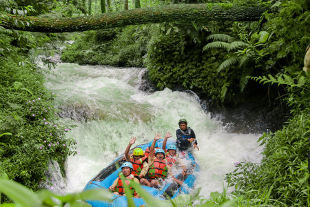 Pangalengan, Bandung-Indonesia December 2022 : A group of men and women are rafting on the river, extreme and fun sport. Group of people water sport raftingのeditorial素材