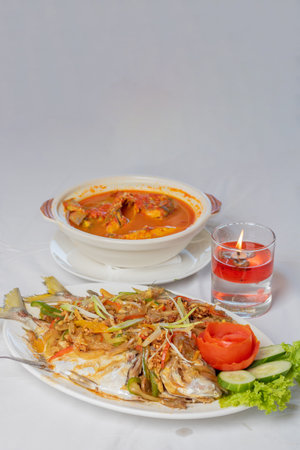 steamed pompano or kuwe fish with sweet and spicy sauce and beautiful garnishesの写真素材
