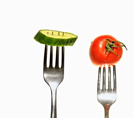 vegetable on fork  with red tomato and cucumberの写真素材
