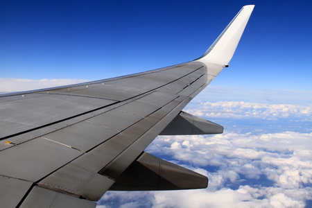 air plane wing with blue sky in the distanceの写真素材