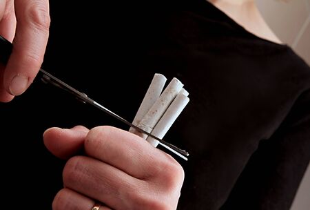 stop smoking cutting out cigarette with scissors and quitting bad habits stock photoの写真素材
