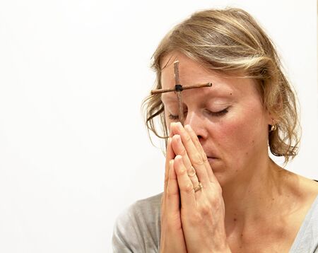 woman praying to god with hands together white background stock image and stock photoの写真素材