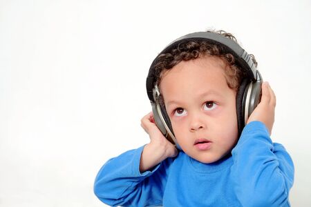 boy with headphones enjoying music   on white background stock photoの写真素材