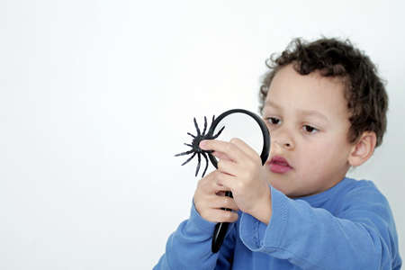 little boy with magnifying glass ready to explore stock photoの写真素材