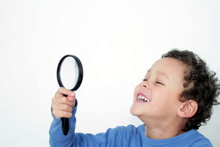boy with magnifying glass ready to explore stock photo