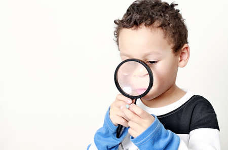 boy with magnifying glass ready to explore stock photo