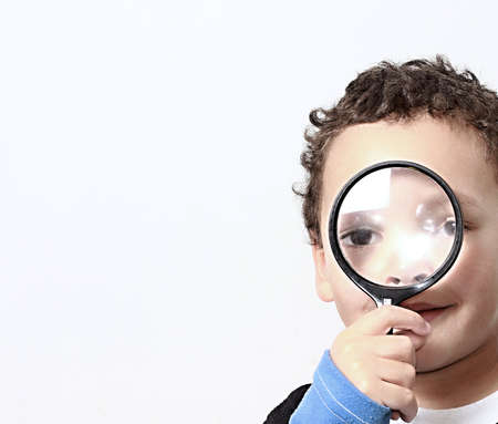 boy with magnifying glass ready to explore stock photo