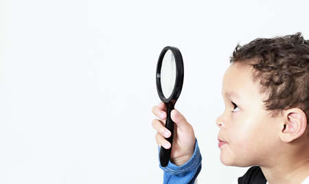 boy with magnifying glass ready to explore stock photo
