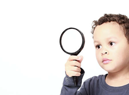 boy with magnifying glass ready to explore stock photo