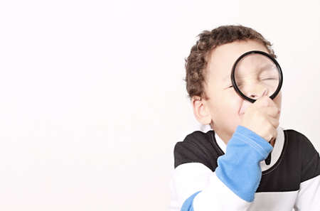 boy with magnifying glass ready to explore stock photoの写真素材
