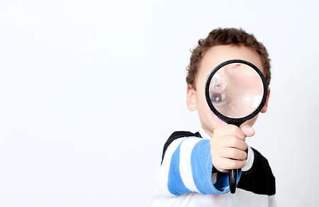 boy with magnifying glass ready to explore stock photoの写真素材