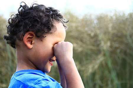 poor boy in poverty with no help alone and all by himself stock photoの写真素材