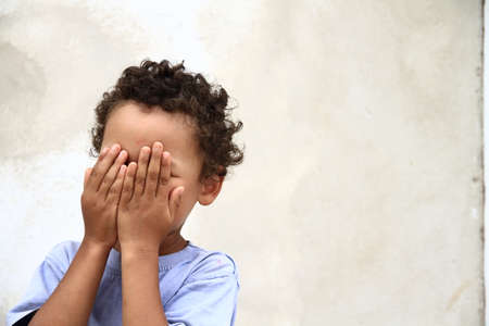 poor boy in poverty with no help alone and all by himself stock photoの写真素材