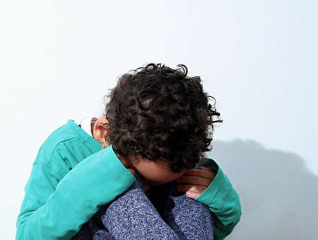 poor boy in poverty with no help alone and all by himself stock photoの写真素材