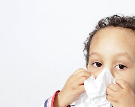 child blowing nose after catching a cold with people stock photography stock photoの写真素材