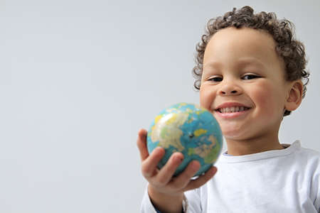 boy holding a globe with white background stock photoの写真素材