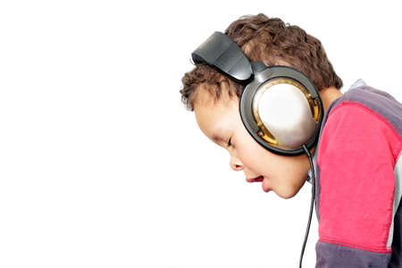 child with headphones enjoying music on white background stock photoの写真素材