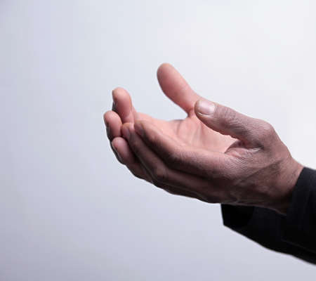 man praying to god with hands together on black background stock photoの写真素材