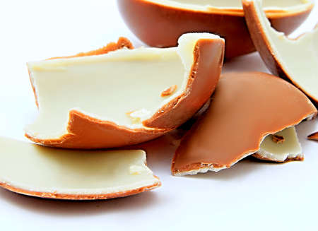 chocolate Easter eggs displayed in many colours on white background stock photoの写真素材
