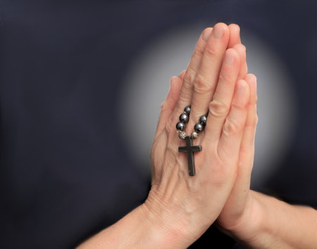 man praying to god with hands together Caribbean man praying with black background stock photos stock photoの写真素材