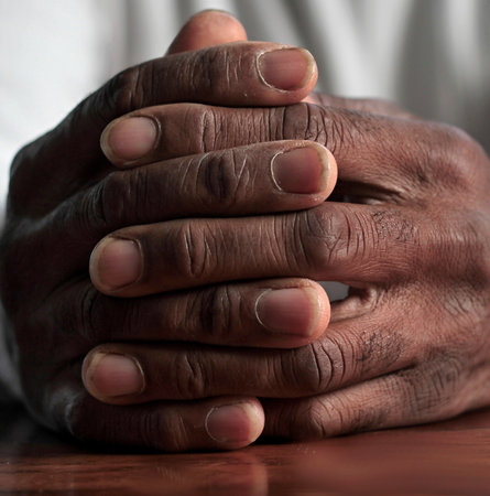 man praying to god with hands together Caribbean man praying with darck background stock photos stock photoの写真素材
