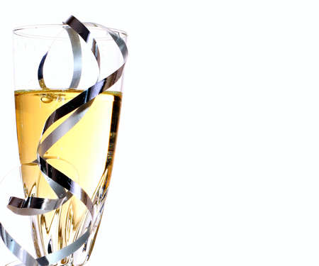 Champagne glass with ribbons on a white background with copy spaceの写真素材