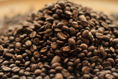 Coffee beans on wooden background. Close-up. Selective focus.