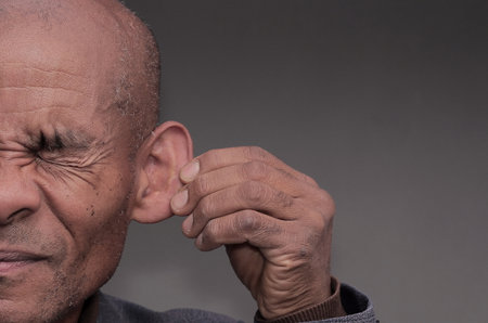 man suffering from deafness and hearing loss stock photo
