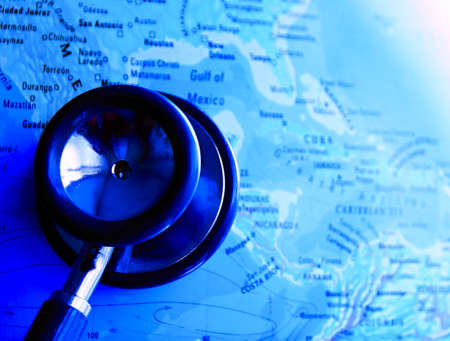 Stethoscope and map of the world on a blue background.